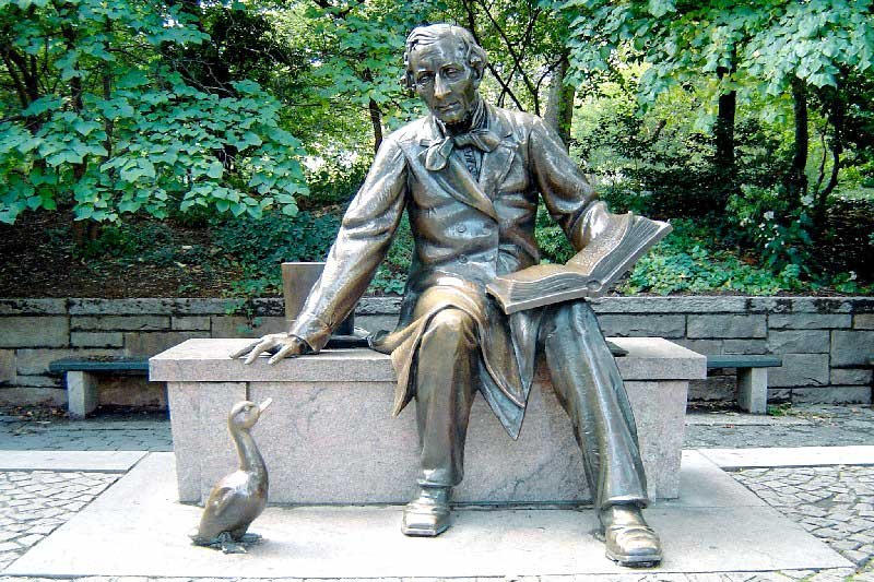 The Hans Christian Andersen statue in Central Park, depicting the author seated on a granite bench reading The Ugly Duckling