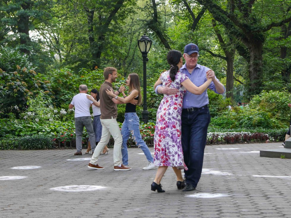 Couples dancing Argentine tango on the Mall in Central Park with trees in the background