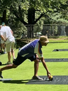 Lawn bowler preparing to roll on the Central Park Bowling and Croquet Greens
