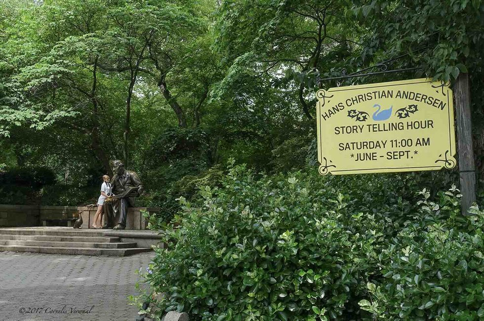 Hans Christian Andersen statue with storytelling hour sign in Central Park