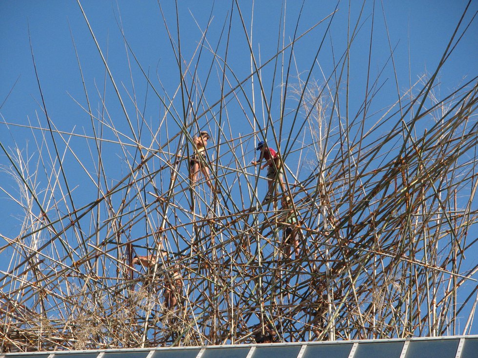 Workers on Met. roof installing "Big Bambú: You Can't, You Don't, and You Won't Stop"